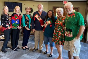 Ugly Sweater Contest - Lorrie (second from left) took first place in a sweater she saved from the 1980's. 