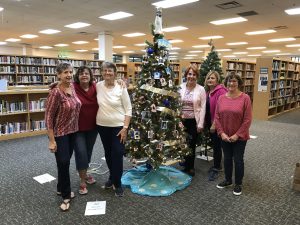 AAUW Flagler members with our holiday tree.